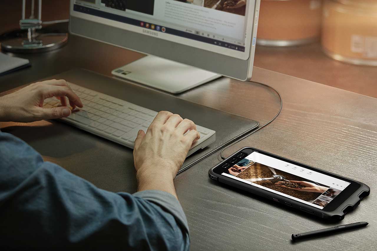 person using a Samsung Tab Active3 in DeX mode to connect to a screen and keyboard