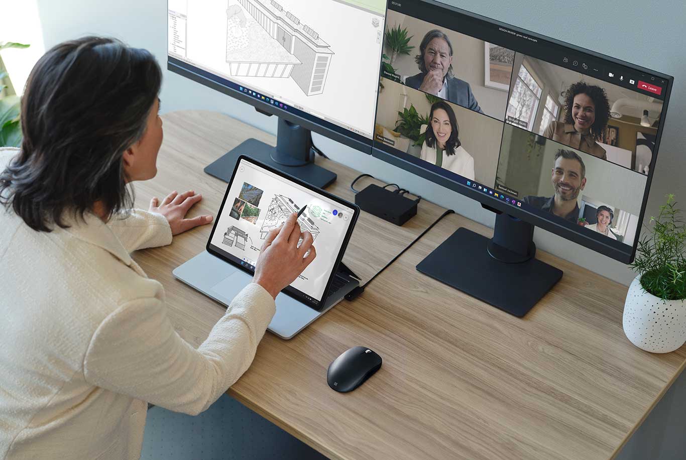 Man in an office using a Surface Laptop Studio