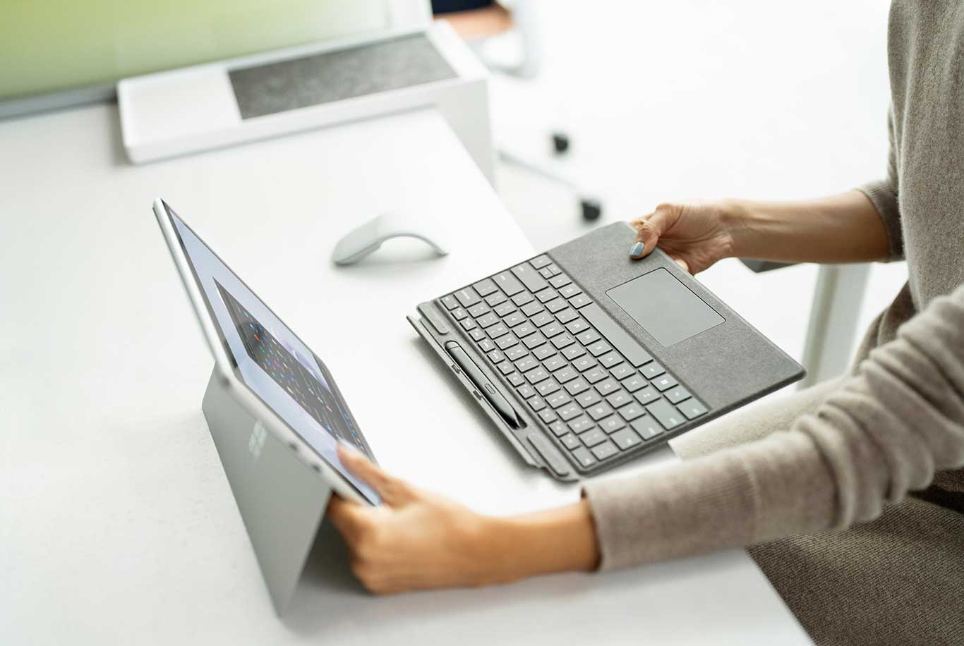 sitting at a desk separating the keyboard from the surface